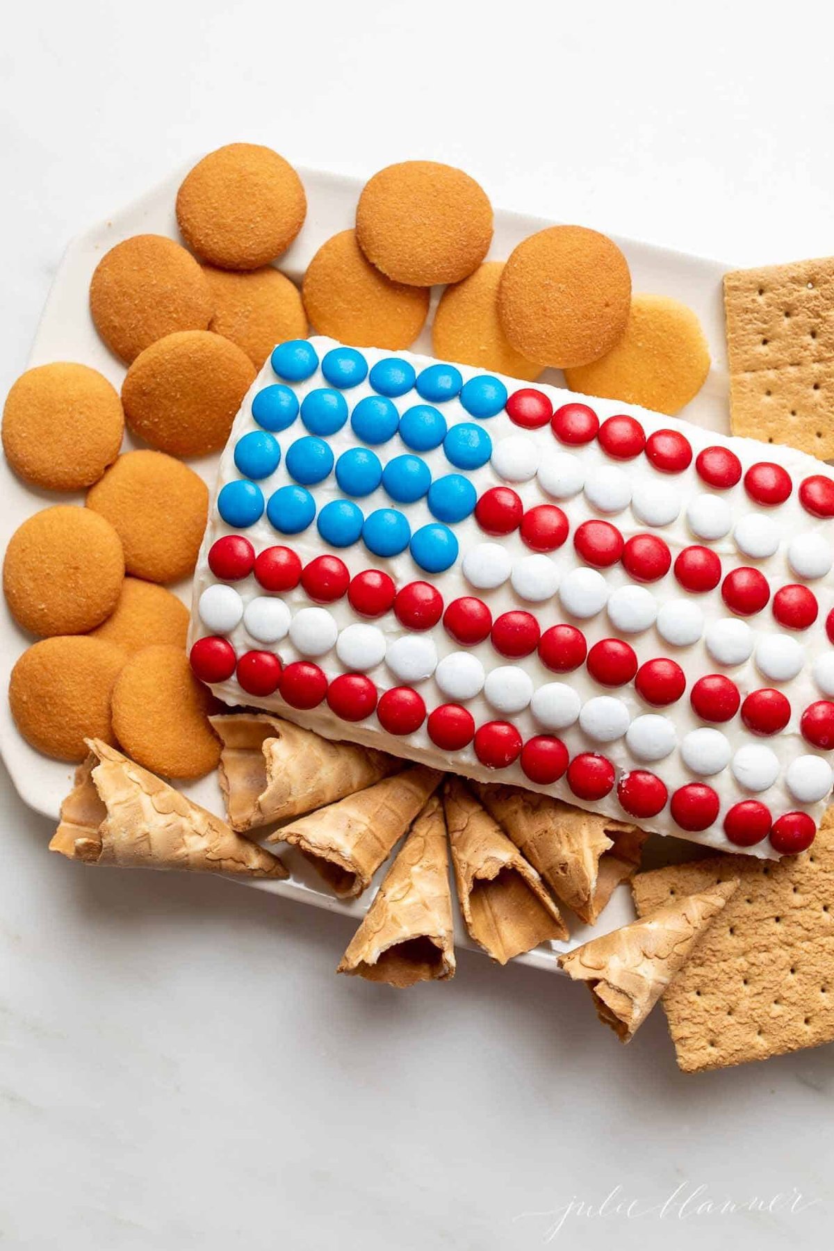 a funfetti dessert cheeseball made into a flag for a red white and blue dessert