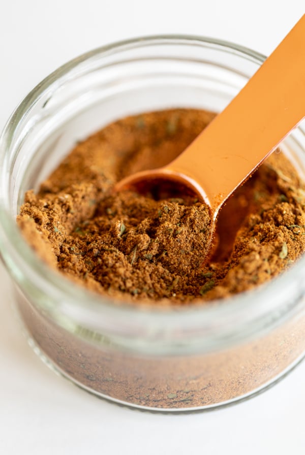 Copper measuring spoon in jar of seven spice