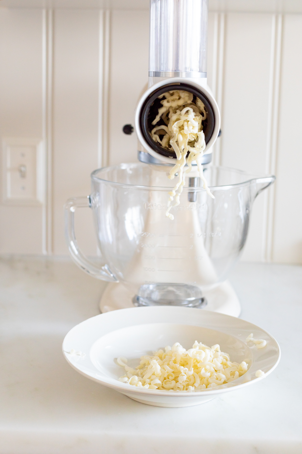 KitchenAid shredder shredding mozzarella into bowl