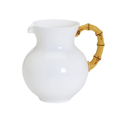 a white pitcher with a bamboo handle for outdoor entertaining