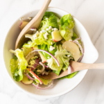 An apple salad in a white bowl