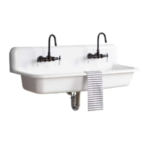 A white wall-mounted sink with two faucets.