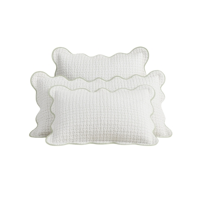 A white scalloped set of bed pillows from Julia Berolzheimer for Pottery Barn