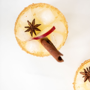 A fall cocktails drink with cinnamon sticks and star anise.