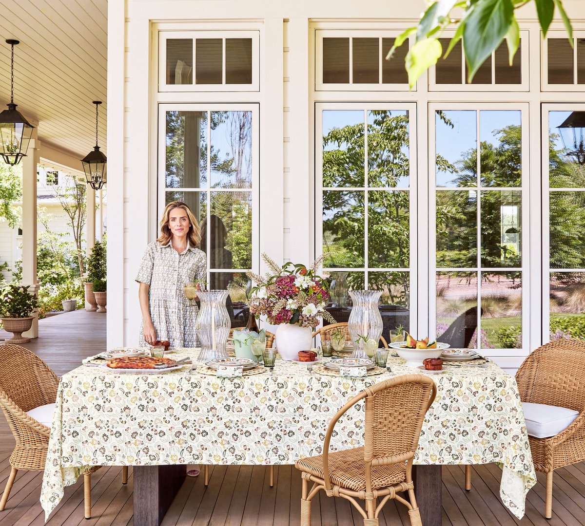 Julie Berolzheimer the designer, setting up an outdoor dining table for Pottery Barn. 