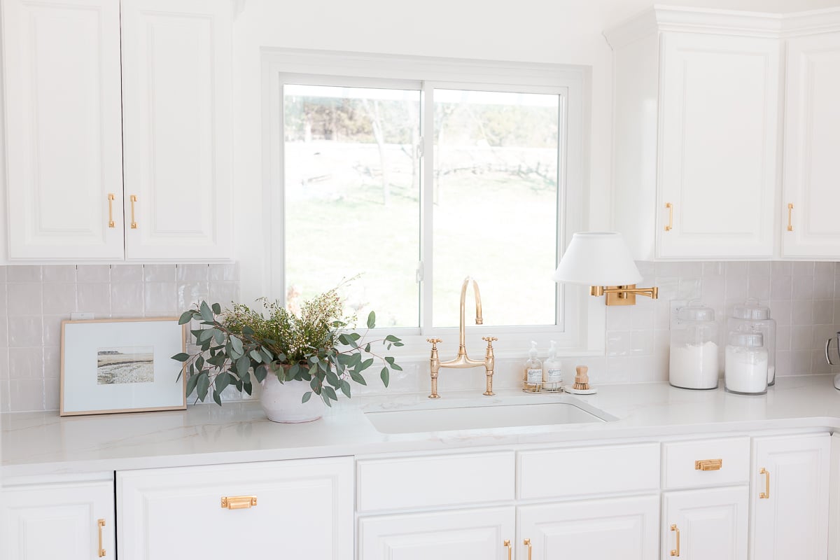 Square stacked tile backsplash in a white kitchen.