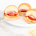 Grinder sandwiches on a white plate.