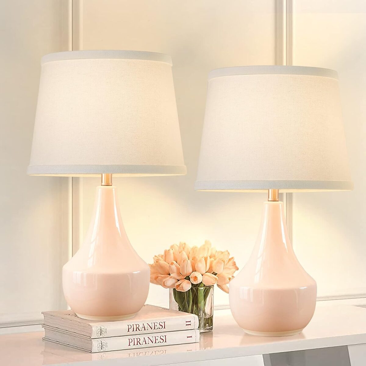 Two pink table lamps on a white table available for Prime Day.