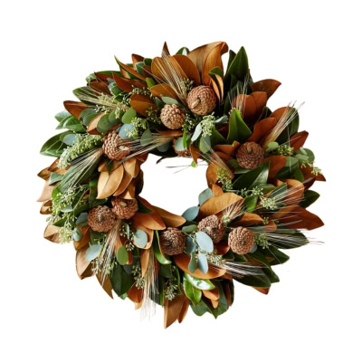 A fall wreath made of brown and green leaves, adorned with pinecones and small sprigs of greenery.