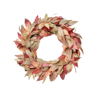 A fall wreath made of dried, multicolored leaves in shades of red, green, and brown, arranged in a circular shape against a white background.