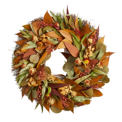 Fall wreath with autumn leaves and berries on a white background.