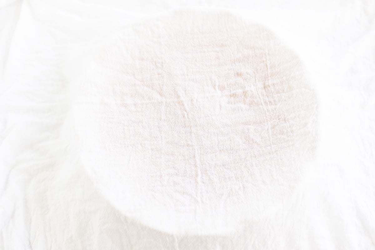 An image of a white cloth on a table with apple cinnamon rolls.
