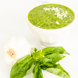 A bowl of nut-free green pesto with garlic and basil.