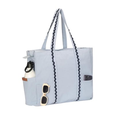 A light blue tote bag with black wavy trim, perfect for Prime Day, featuring two shoulder straps, a side pocket holding a water bottle, and sunglasses hanging from the front.