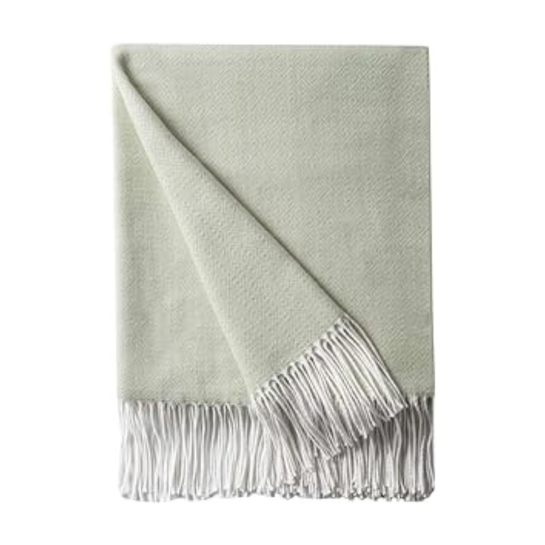 A light green throw with white fringes on Prime Day.