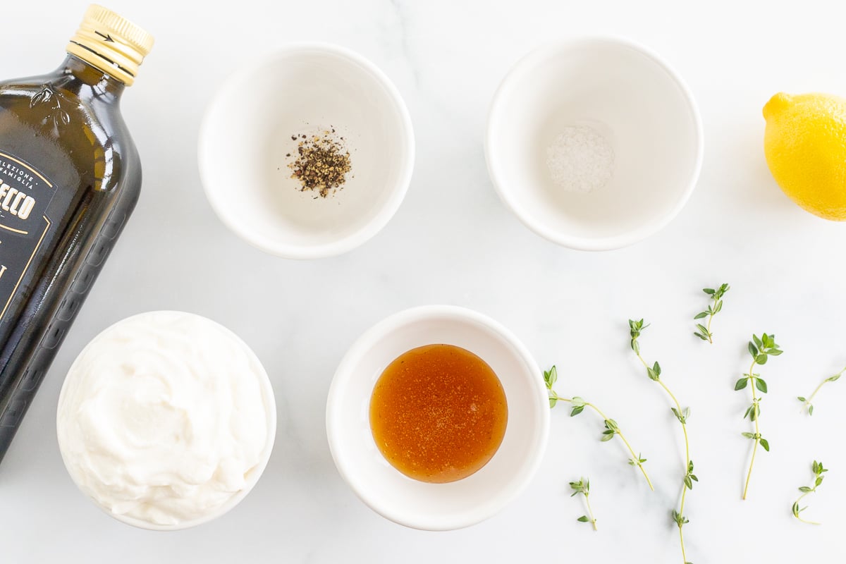 Ingredients for whipped ricotta on a white marble surface