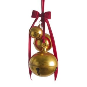 Three brass bells of varying sizes hang from red ribbons tied in a bow, adding a festive touch.