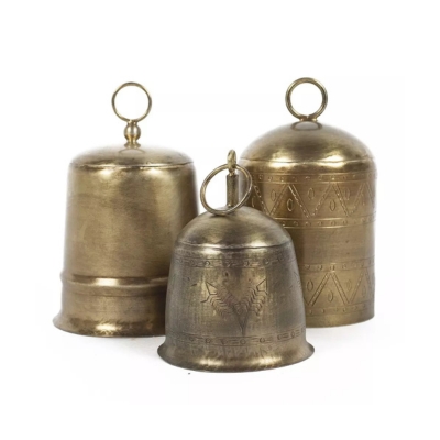 Three beautiful brass bells on a pristine white background.