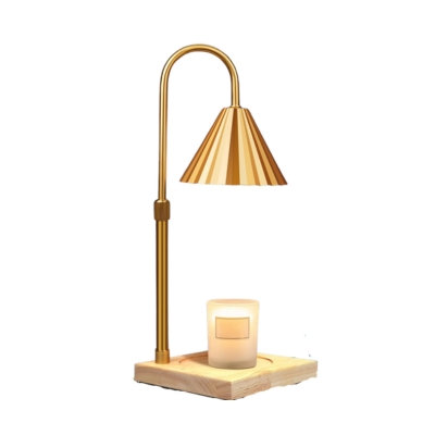 A gold table lamp with a candle on top.