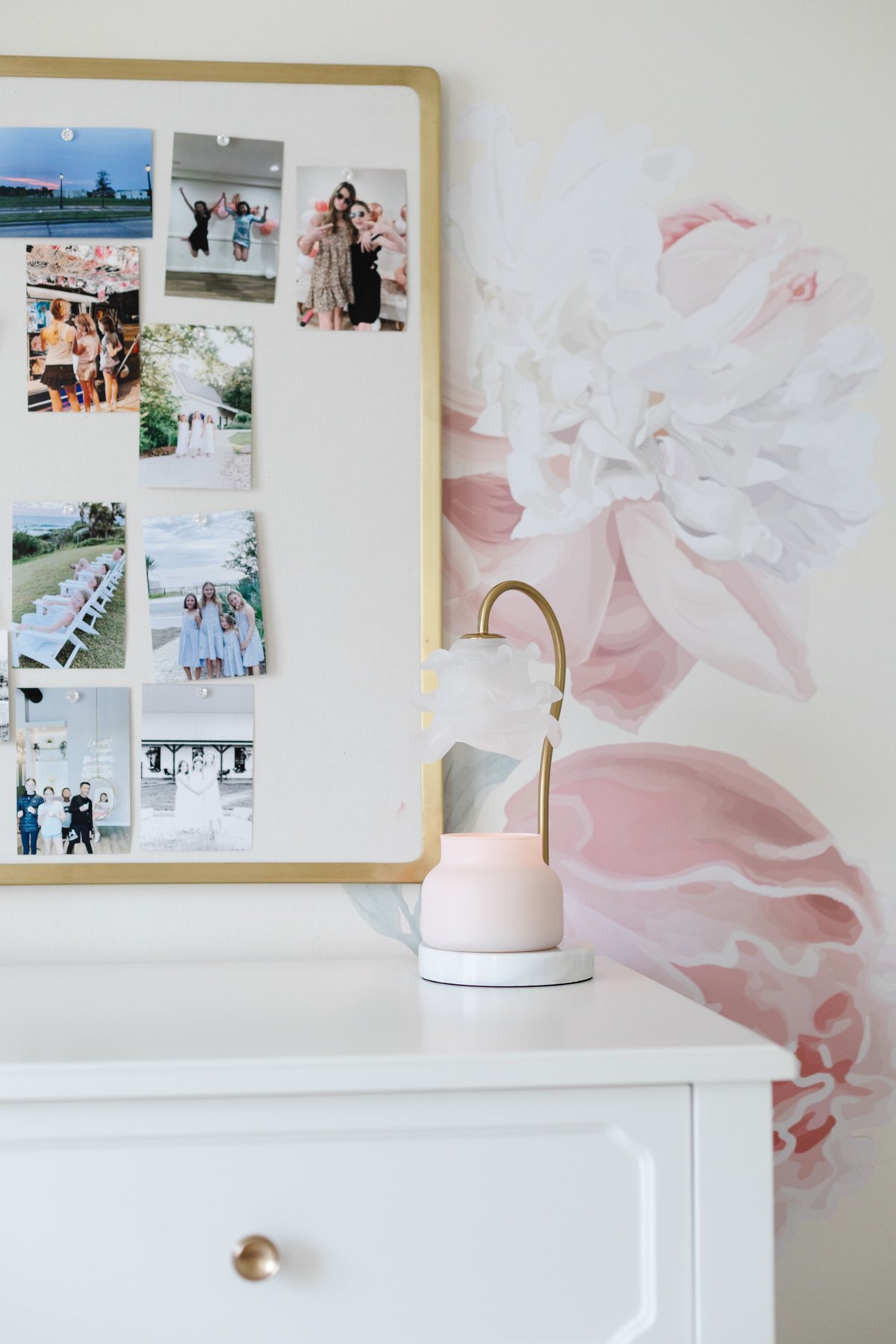 A warmer lamp for candles with a ruffled glass shade in a pink floral girl's room.