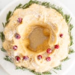 A Christmas bundt cake topped with cranberries and powdered sugar.