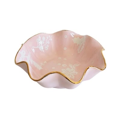 A pink bowl with gold trim, perfect for holiday season Christmas decorations.