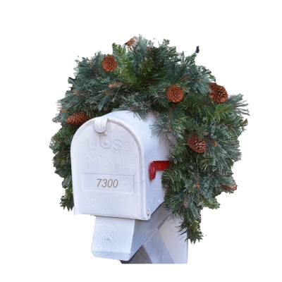 A festive mailbox adorned with a Christmas wreath and pine cones, creating an inviting display for the holiday season.