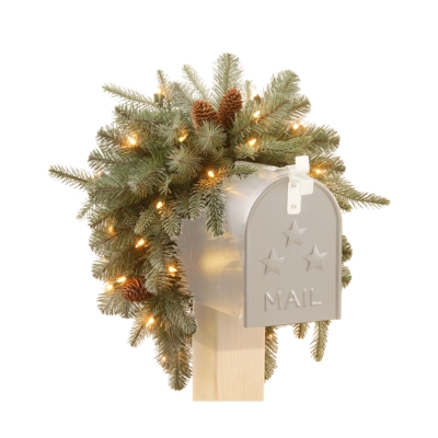 A festive mailbox adorned with a christmas tree and pine cones, showcasing delightful Christmas mailbox decorations.