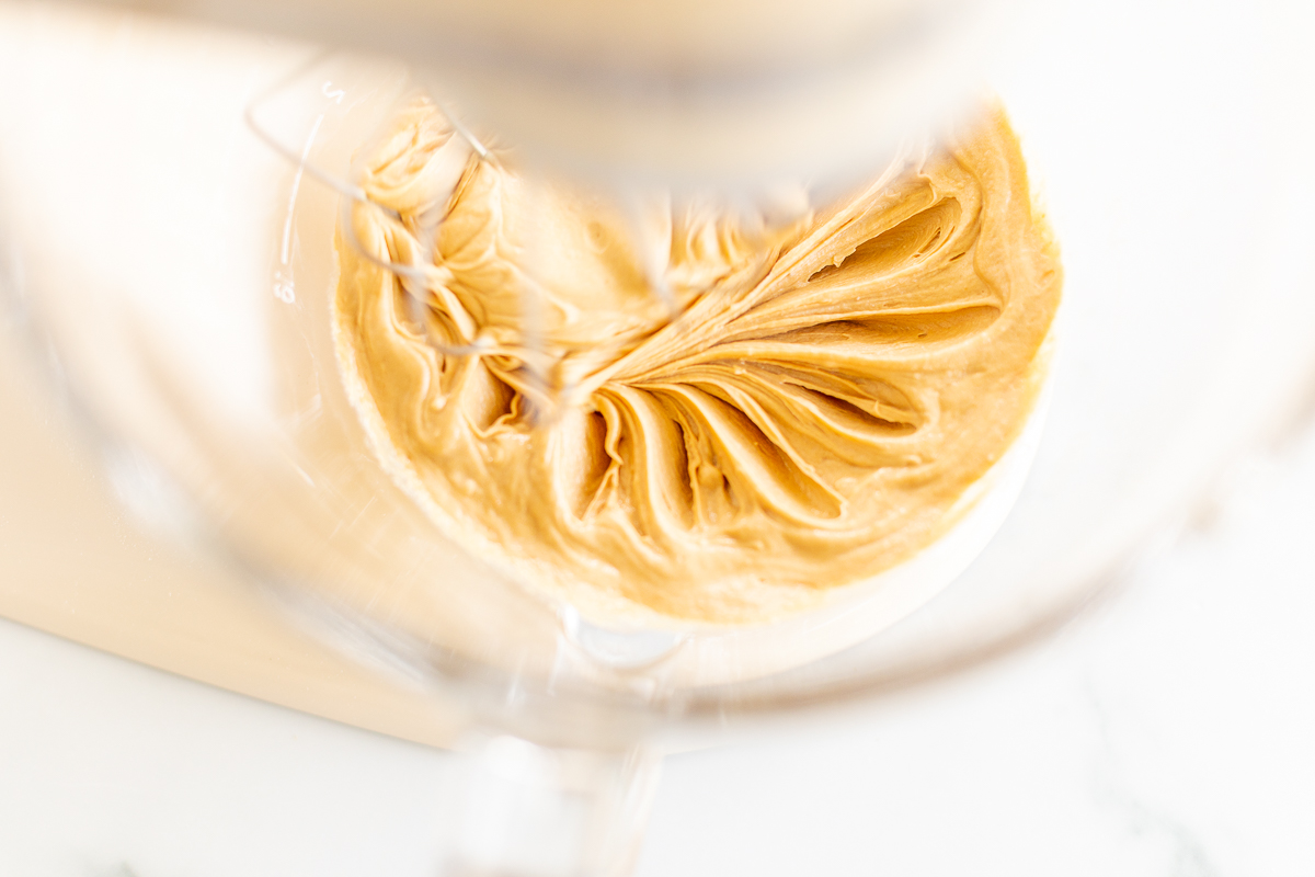 A close up of cookie butter in a mixer.