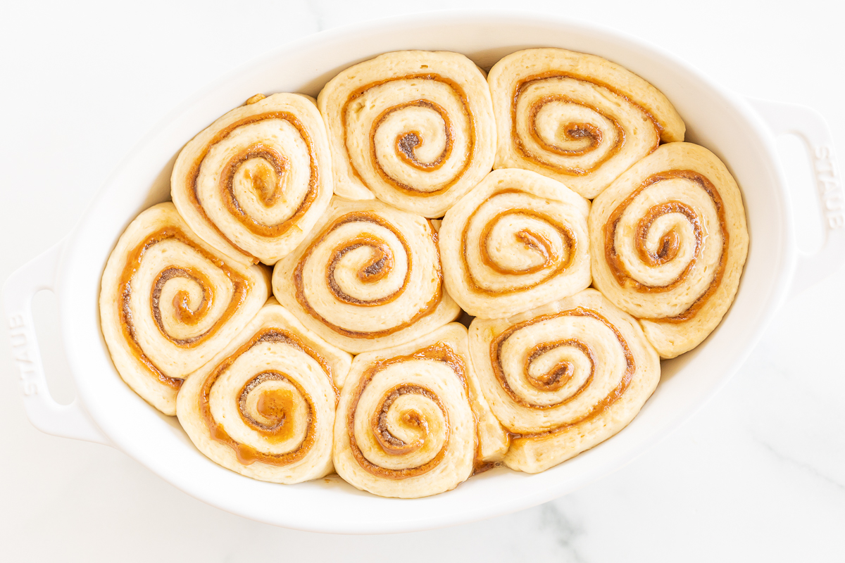 Cookie Butter Cinnamon Rolls in a white baking dish.