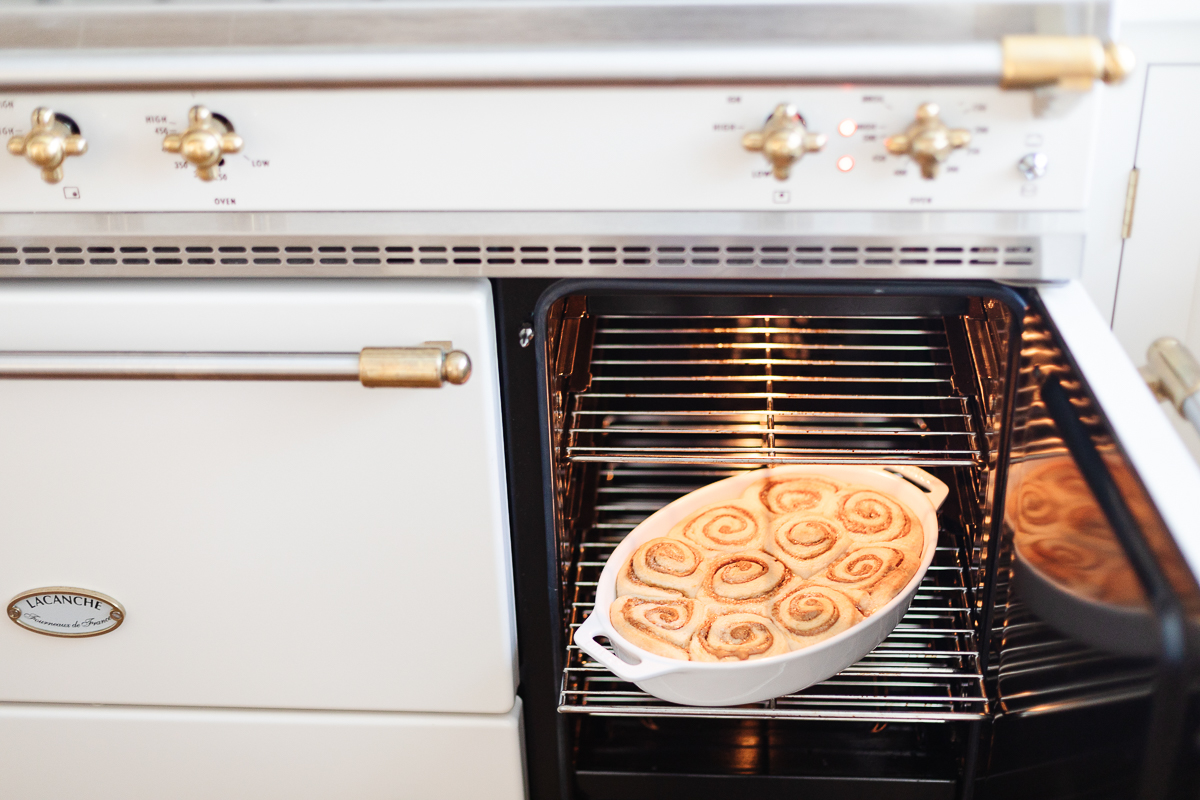 An oven with a bowl of Cookie Butter Cinnamon Rolls in it.