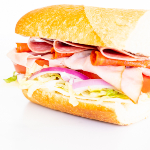 An Italian BMT sandwich with deli meat, lettuce, tomatoes, and onions.