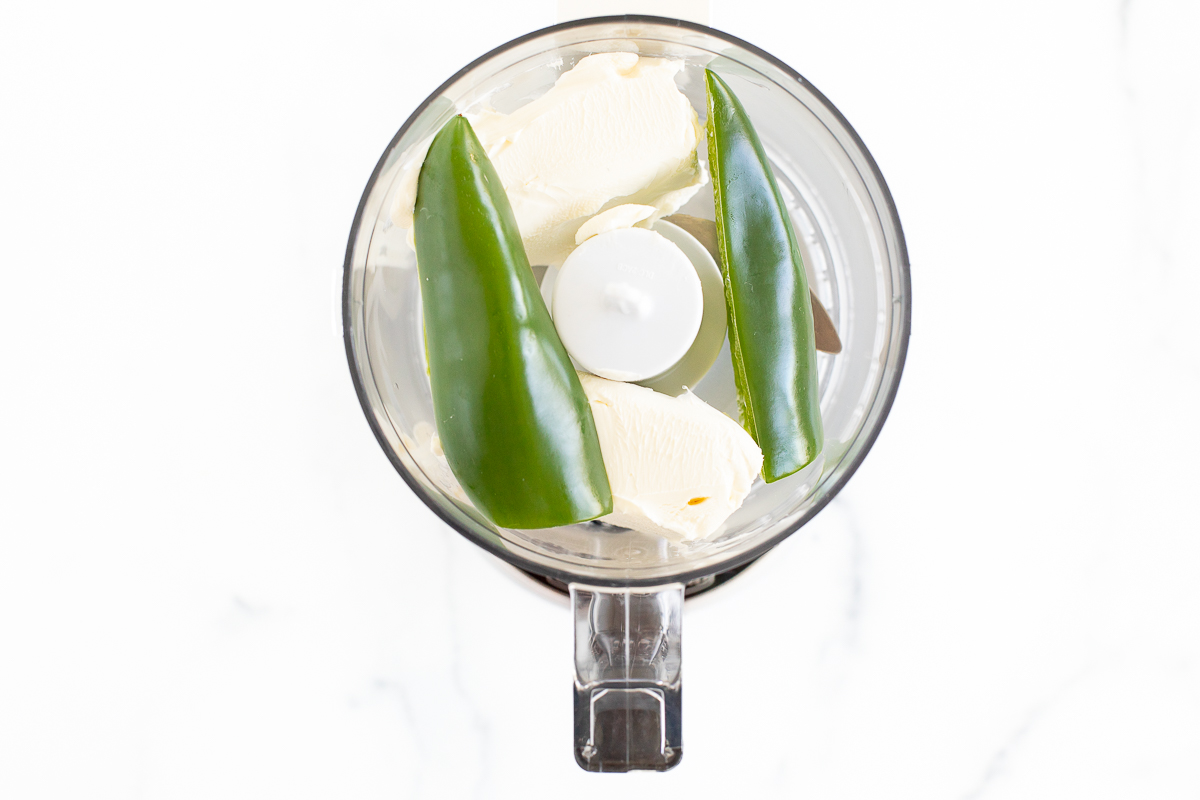Jalapeno and cream cheese inside a food processor