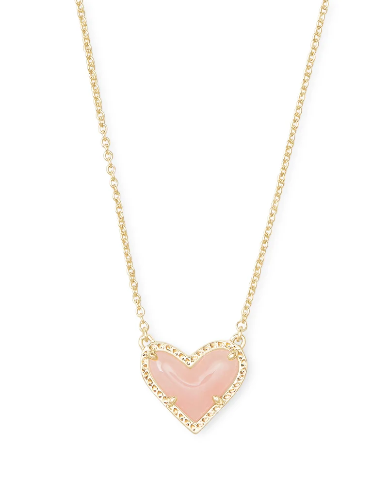 A pink heart necklace on a gold chain, perfect for black Friday.