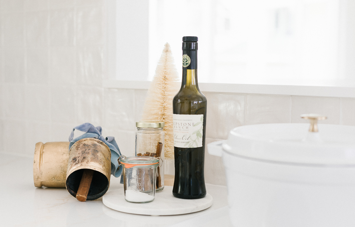 A bottle of wine sits on a kitchen counter next to a sink, making it an ideal gift for anyone who loves kitchen gifts.