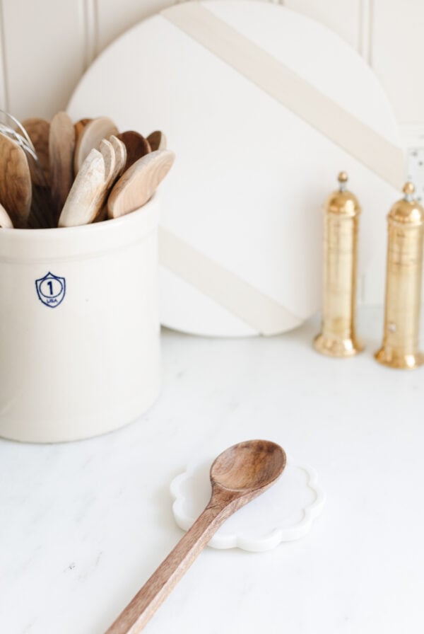 A white bowl with wooden spoons, perfect for kitchen gifts.
