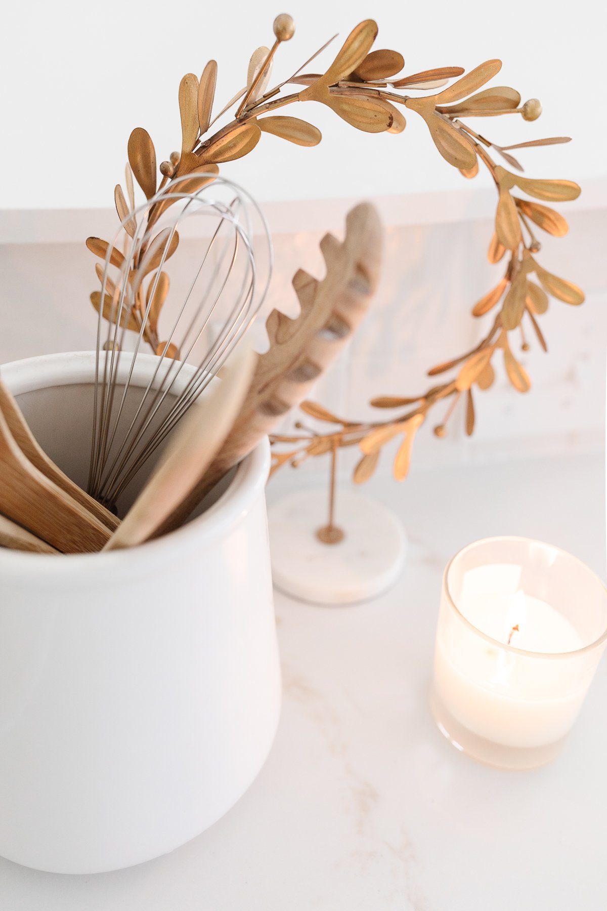 A gold laurel wreath on a white kitchen countertop