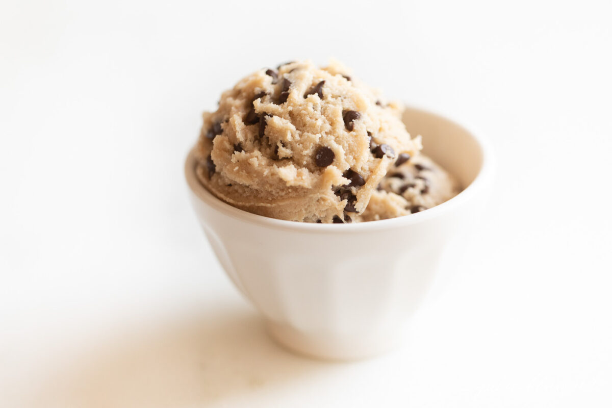 A delicious serving of chocolate chip ice cream, with two flavorful scoops perfectly nestled in a white cup.