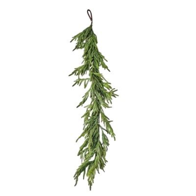 A green norfolk pine garland hanging on a white background.