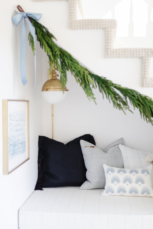 A stairway adorned with a norfolk pine garland for Christmas