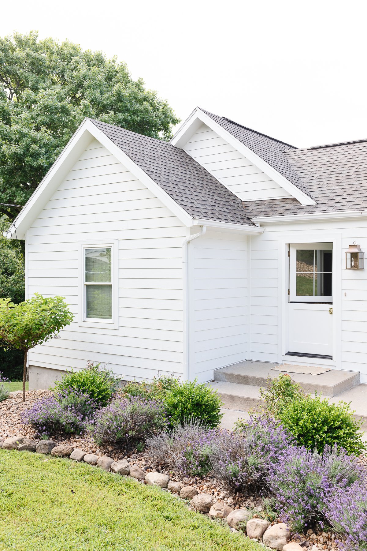 A home with a James hardie Arctic White exterior and a Dutch door. 