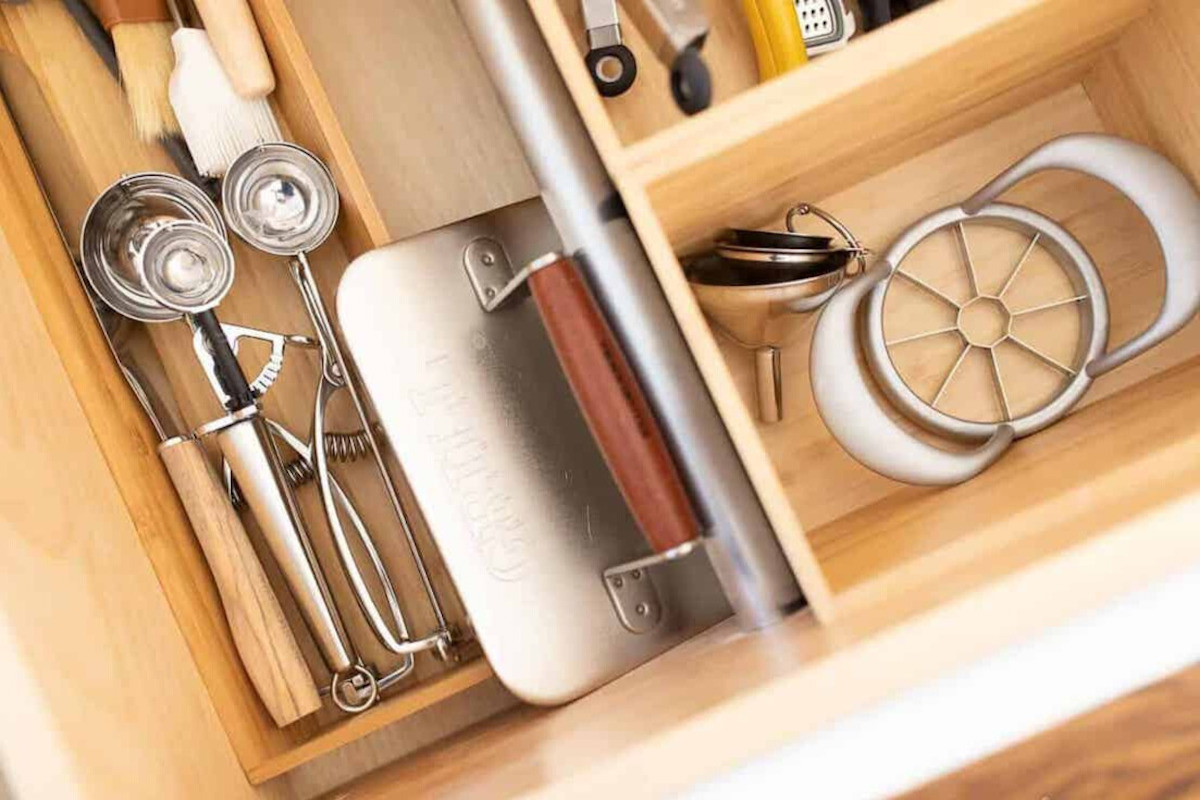 A kitchen drawer fully organized with a silverware drawer organizer.
