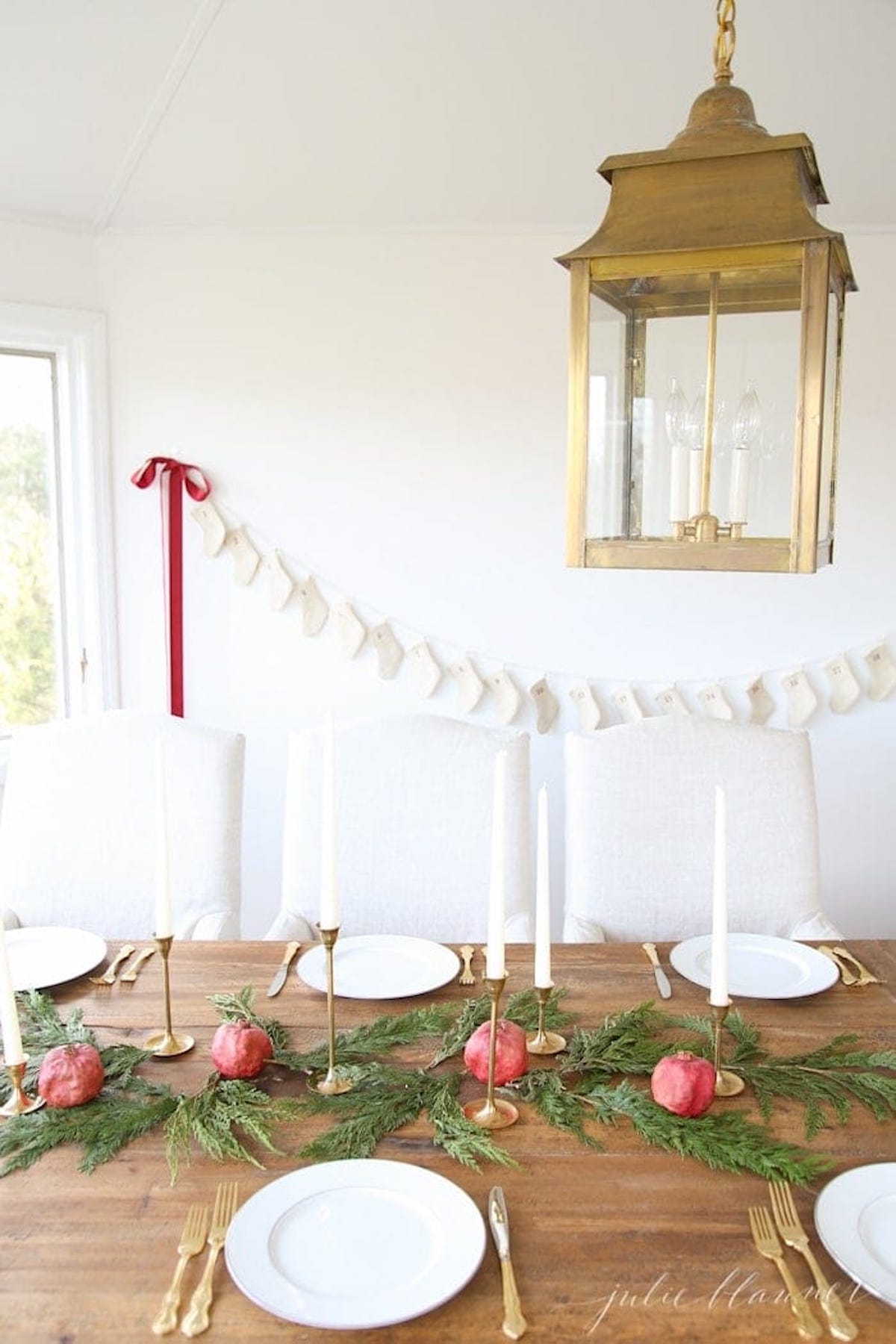 A festive Christmas table setting adorned with a charming lantern centerpiece and beautifully arranged place settings.