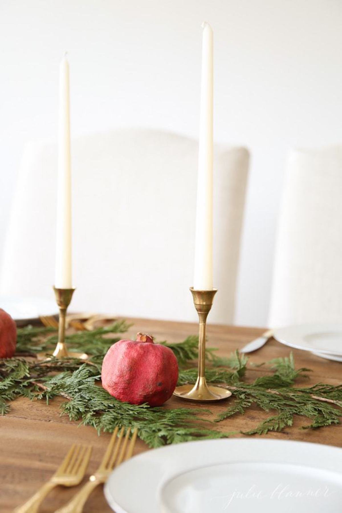 A festive Christmas candle centerpiece featuring pomegranates.