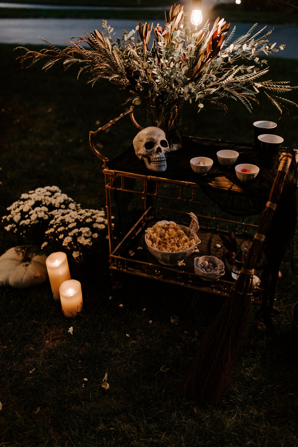 A table with LED candles and skeletons on it for a Halloween party.