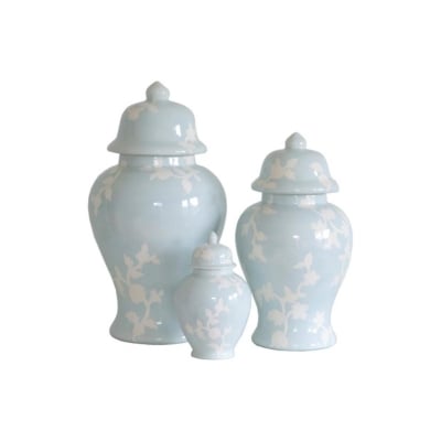 Three blue urns with white flowers on them.