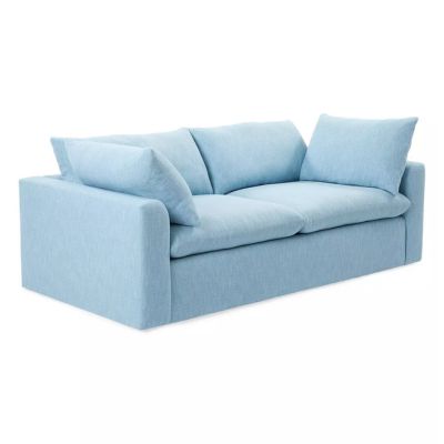 Light blue, modern upholstered Serena and Lily Sofa with two seat cushions and two back pillows, featuring wide armrests and a boxy design.