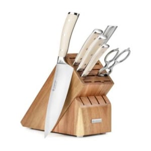 A set of kitchen knives with light handles in a wooden block, perfect for enhancing your kitchen counter organization, featuring five knives and a pair of scissors.