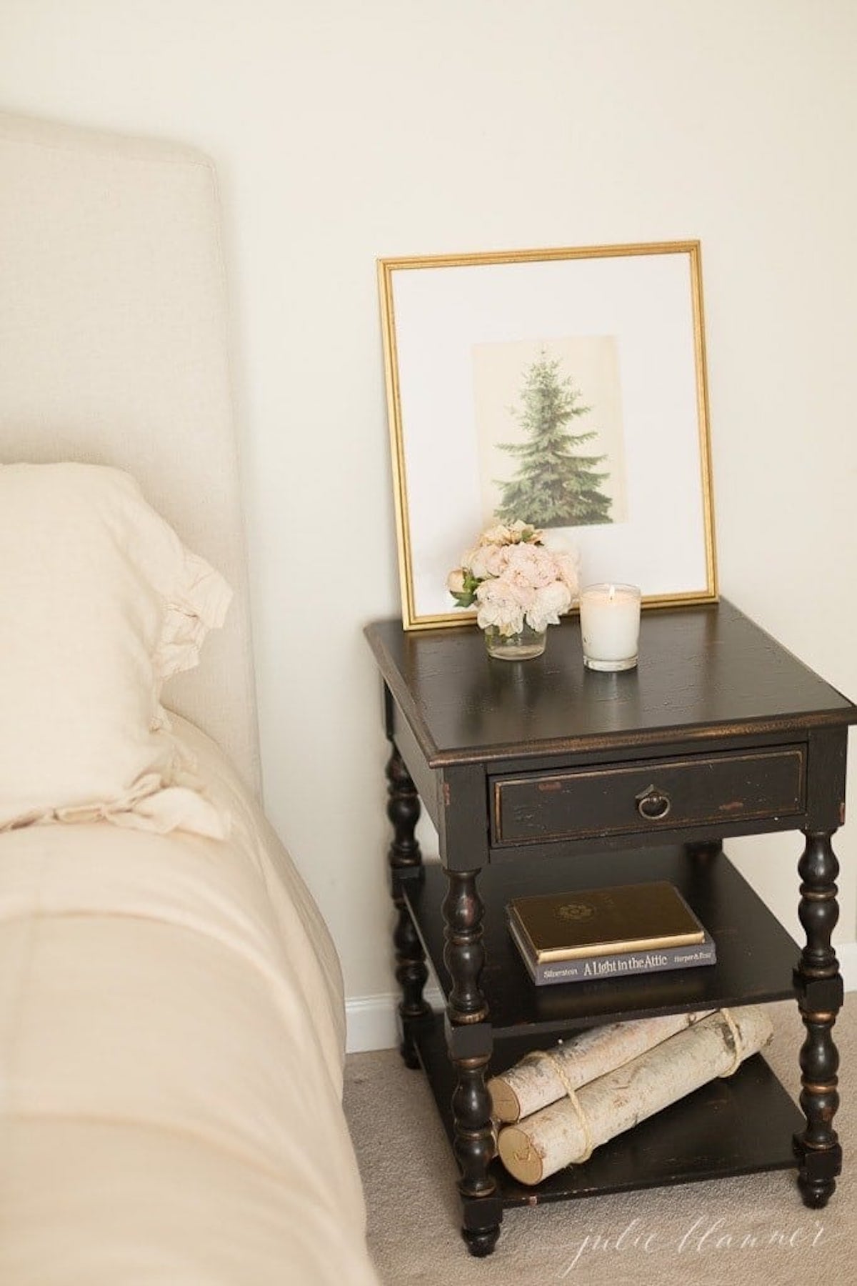 A black nightstand adorned with a captivating framed picture depicting the enchantment of Christmas magic.