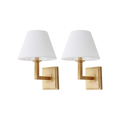 A pair of gold bathroom sconces with white shades.